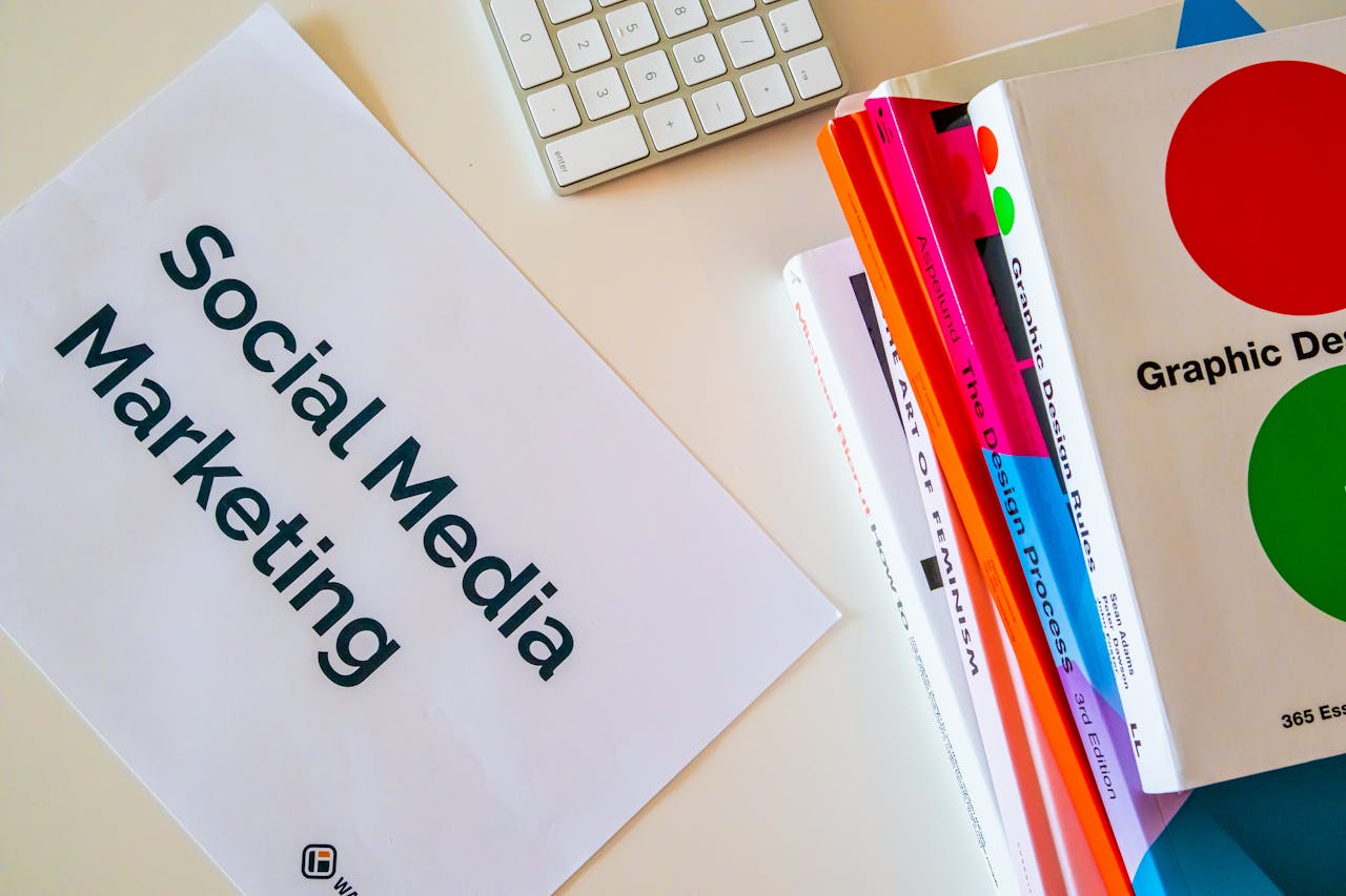 Close-up of a Pile of Books and a Piece of Paper Saying Social Media Marketing Lying on a Desk